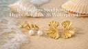 Several hypoallergenic gold-plated jewelry laying on the beach to prove it is waterproof