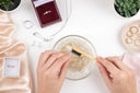 cleaning the jewelry on the container with water and using tooth brush