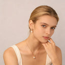 model wears delicate heart shape zircon necklace with earrings