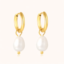 Minimalist gold hoop earrings on light beige background from verosteel jewelry