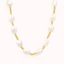 irregular baroque pearl necklace with gold chain on soft beige background by verosteel jewelry