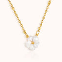 flat lay picture of a gold plated necklace with plum blossom pendant by verosteel jewelry 