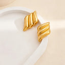 Triple wing earrings on the white plate with 18k gold plated finish