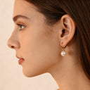 Woman wearing gold plated stainless steel earrings in close up look, everyday fashion styling