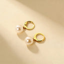 Minimalist 18k gold plated earrings displayed flat lay on neutral color background