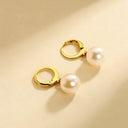 Close-up of minimalist gold plated jewelry in natural sunlight