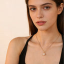 Model wearing a Pearl Pendant Necklace featuring a freshwater pearl and 18k gold plated design.