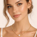 Close-up of minimalist necklace resting on collarbone
