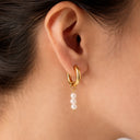 Créole asymétrique dorée avec des perles