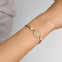 North star & pearl charm chain bracelet on wrist to showcase the details 