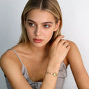 model wearing north star & pearl charm chain bracelet with calm facial expression