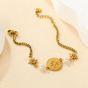 North star & pearl charm chain bracelet laying flat on the beige color background