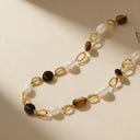 Stainless steel bracelet stack with tiger eye and pearl design, styled for daily wear collection