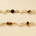 close up of the bracelet with tiger eye and pearl charms